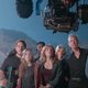 The director filming the casts of Jurassic park and world.